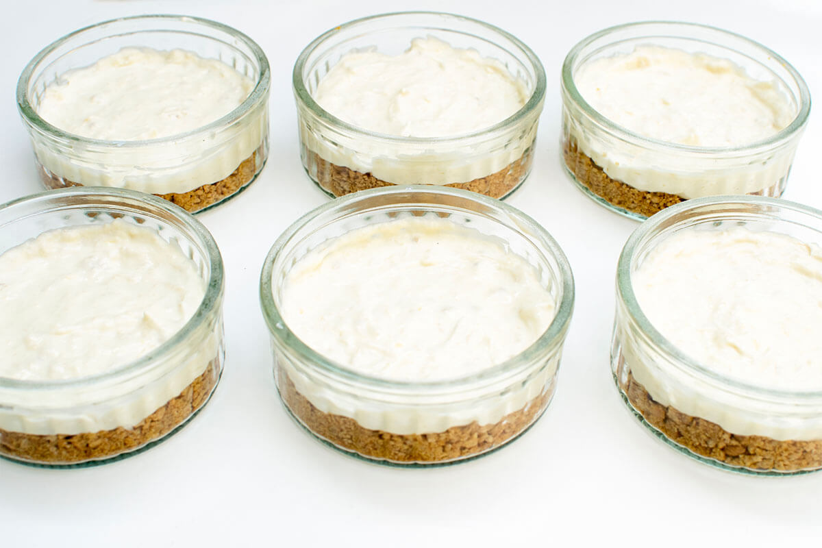 6 ramekins filled with butter and biscuit mixture, topped with cream cheese mixture