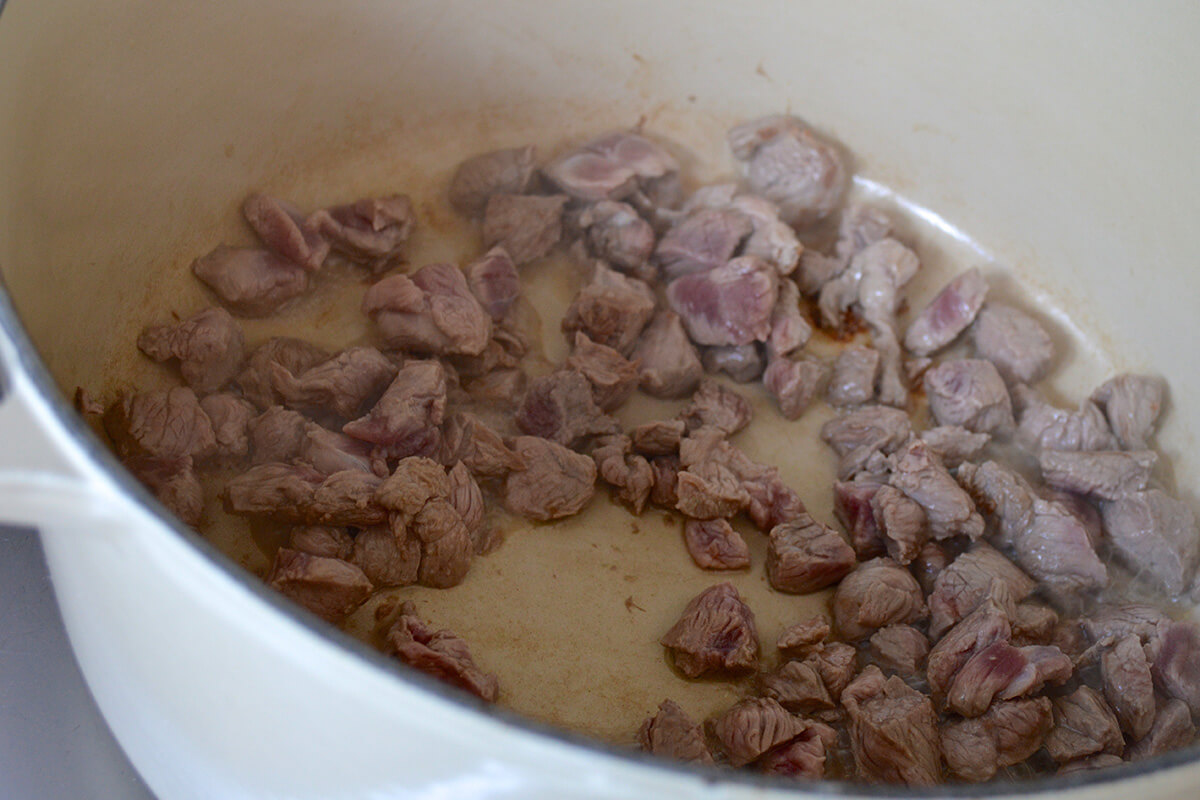 Lamb being fried in a saucepan