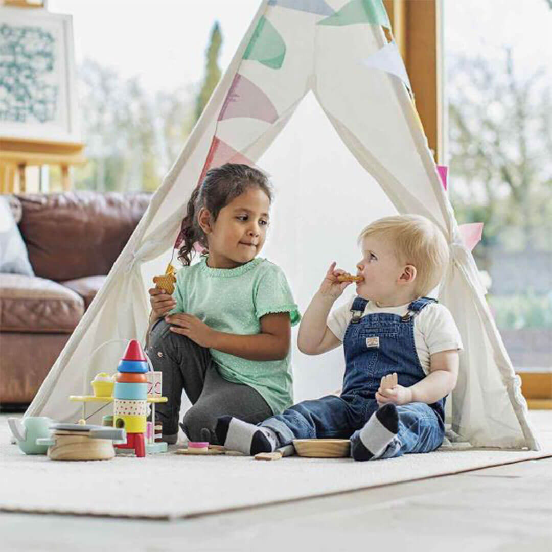 Two toddlers sitting and playing together